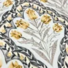 Hanging swing upholstered in ivory fabric with small mustard floral prints, charcoal vines, and taupe leaf patterns.