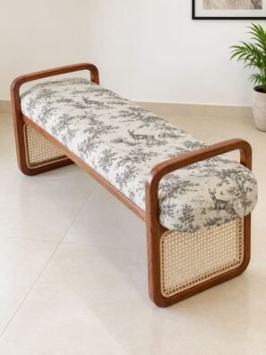 Ivory and charcoal-grey deer and forest printed upholstery fabric on a wooden bench with cane detailing, ideal for luxury furniture and elegant home interiors by RUBY The Furnishing Studio, Ghatkopar East, Mumbai.