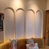 Pichwai-inspired floral arch panel wallpaper with lotus motifs and hand-drawn nature elements